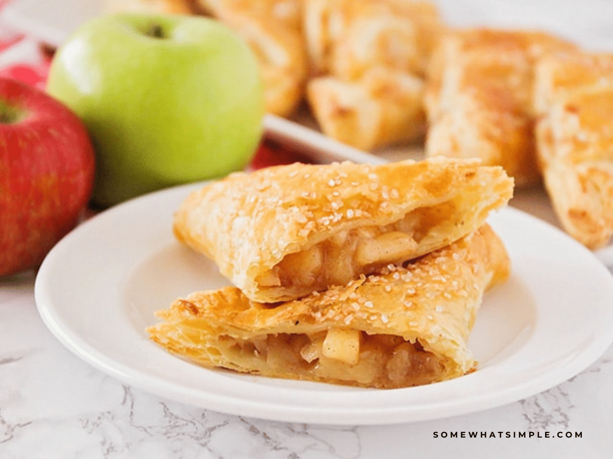 Apple Turnovers plated and cut in half, showing the apple cinnamon inside