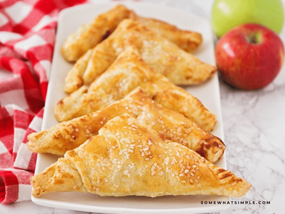 Apple Turnovers lined up on a white serving tray