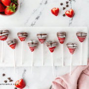 chocolate strawberry heart pops - lined up on a white serving tray