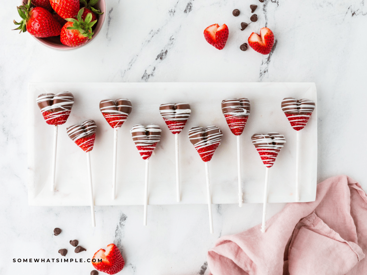 chocolate strawberry heart pops - lined up on a white serving tray