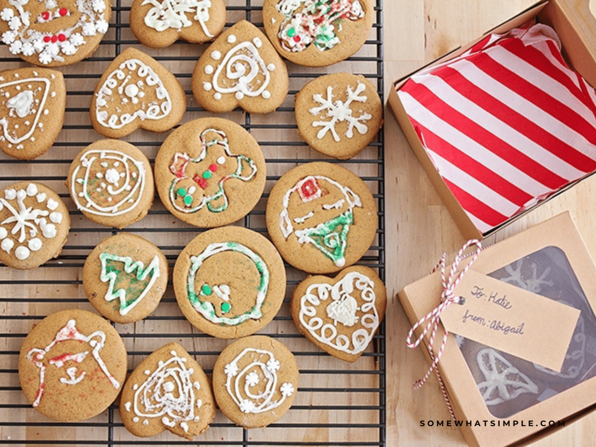 decorated holiday cookies next to gift wrap