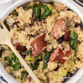 finished product of Sausage and Kale Quinoa in a white dish with gold fork