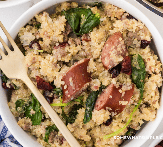 finished product of Sausage and Kale Quinoa in a white dish with gold fork
