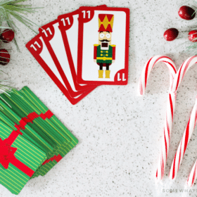 looking down on a deck of cards and candy canes which are used to play this fun variation of the spoons card game.