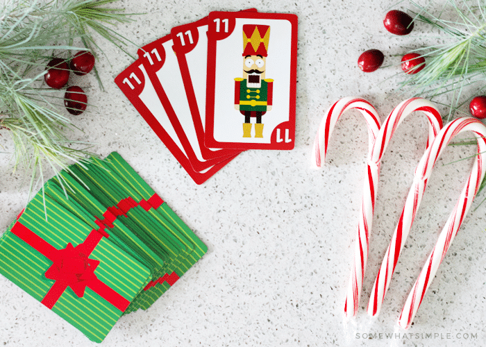 looking down on a deck of cards and candy canes which are used to play this fun variation of the spoons card game.