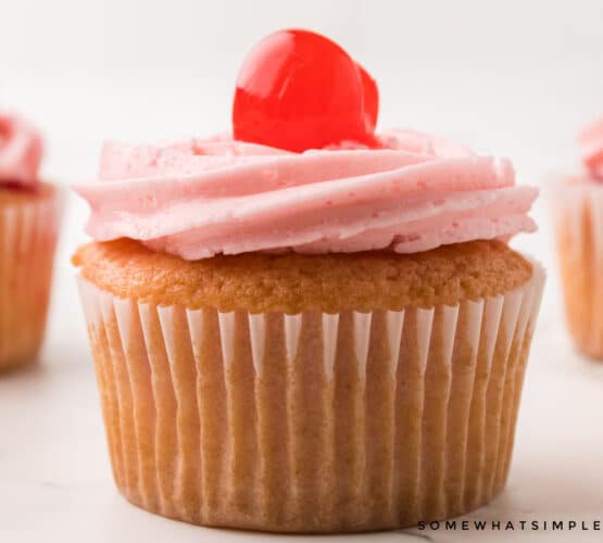 close up of a vanilla cherry cupcake