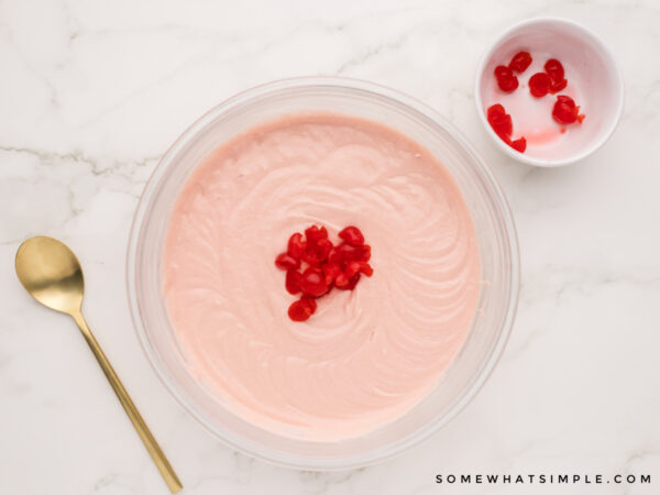 adding chopped cherries to cupcake mix