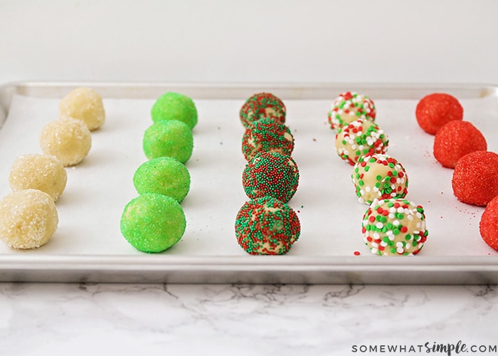 balls of sugar cookie dough that have been rolled in Christmas decorations