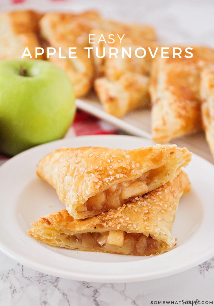 a close up of an apple turnover cut in half with apple filling inside on a white plate with a green apple and more turnovers on a white tray in the background. The words easy apple turnovers is overlayed across the top of the image.