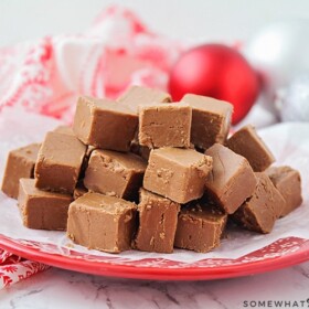 Easy Chocolate Fudge cut in cubes and on a red plate