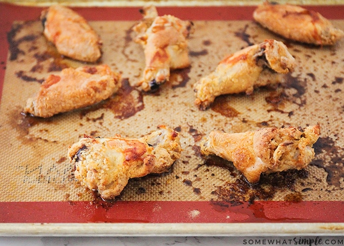 several garlic parmesan chicken wings on a baking sheet taken right out of the oven