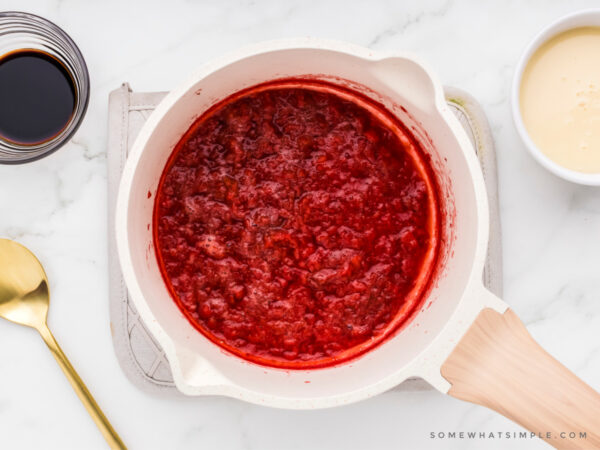 making strawberry sauce in a sauce pan