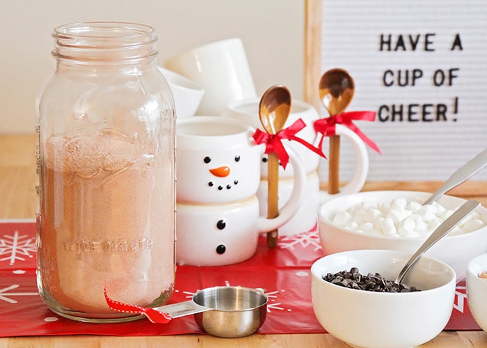 a snowman mug and a jar of hot chocolate mix