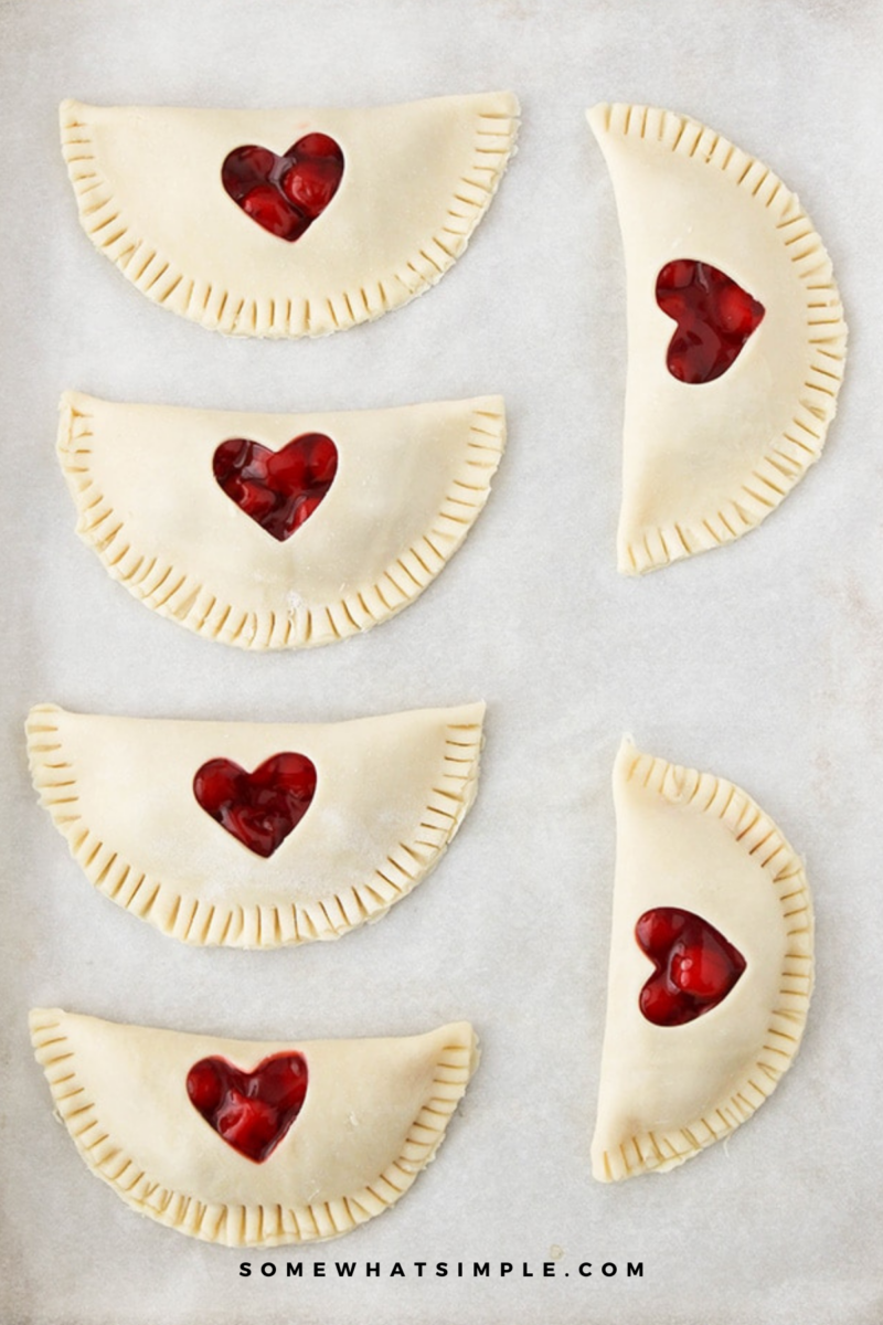 raw Cherry Hand Pies on a baking sheet lined with parchment paper