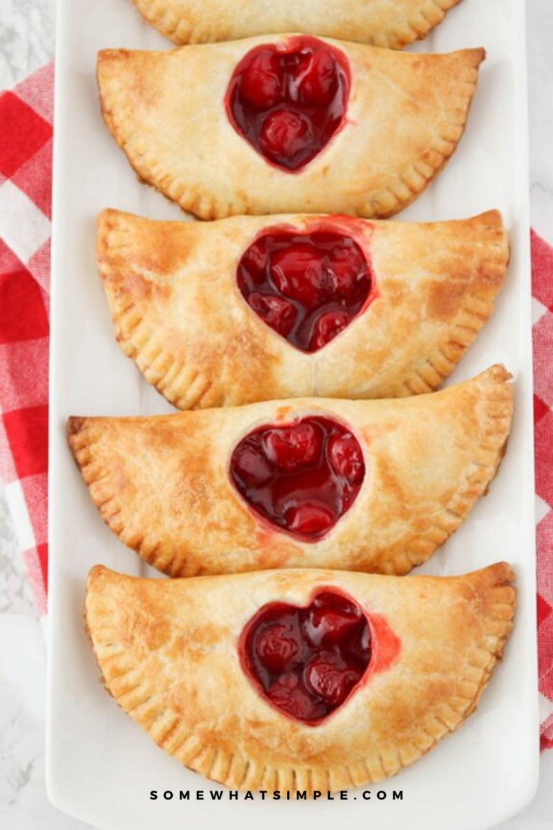 baked Cherry Hand Pies, plated on a white serving tray