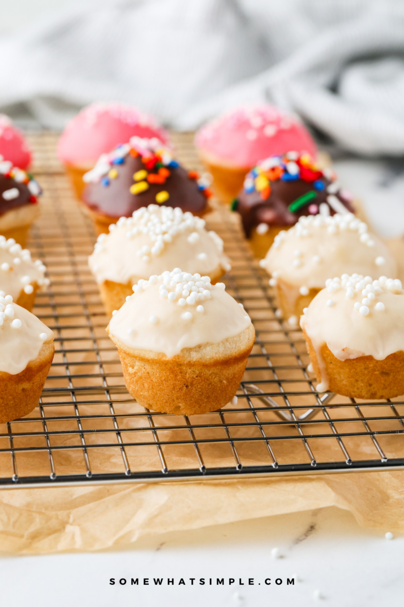 close up of a variety of donut muffins on a cooling rack