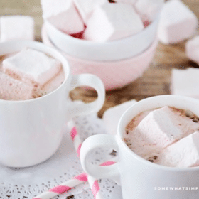 long image of several cups of hot cocoa filled with Strawberry Marshmallows
