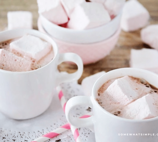 long image of several cups of hot cocoa filled with Strawberry Marshmallows