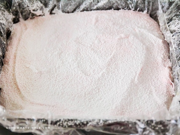 a pan of Strawberry Marshmallows dusted with powdered sugar