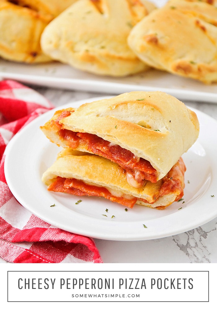 These cheesy pepperoni pizza pockets are a fun, and much less messy, way to enjoy pizza at home!  Baked in a homemade dough and filled with your favorite toppings, these pockets are perfect to eat at home or take with you on the go. #pizzapockets #homemadepizzapockets #pizzapocketswithpizzadough #pepperonipizzapockets #easypizzapockets via @somewhatsimple