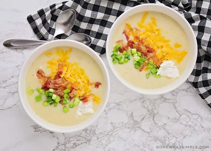 look down on two bowls of loaded baked potato soup