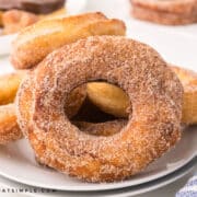 finished spudnuts with cinnamon sugar on a white plate