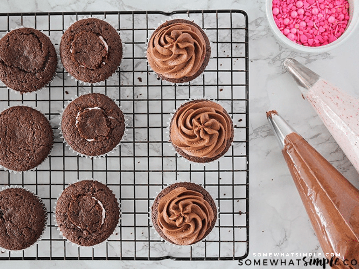 Chocolate fudge cupcakes being frosted