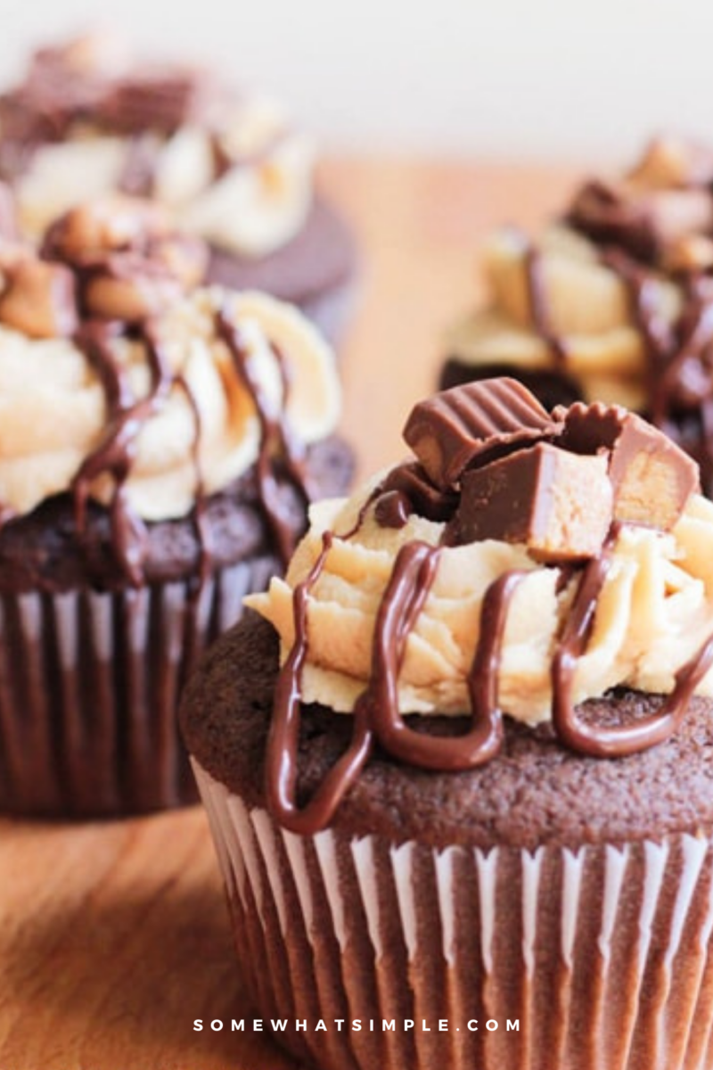close up of several Chocolate Peanut Butter Cupcakes on a butcher block counter