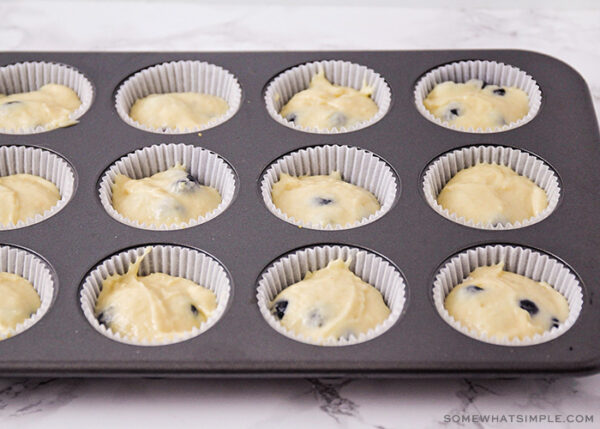 blueberry muffin batter in a muffin pan