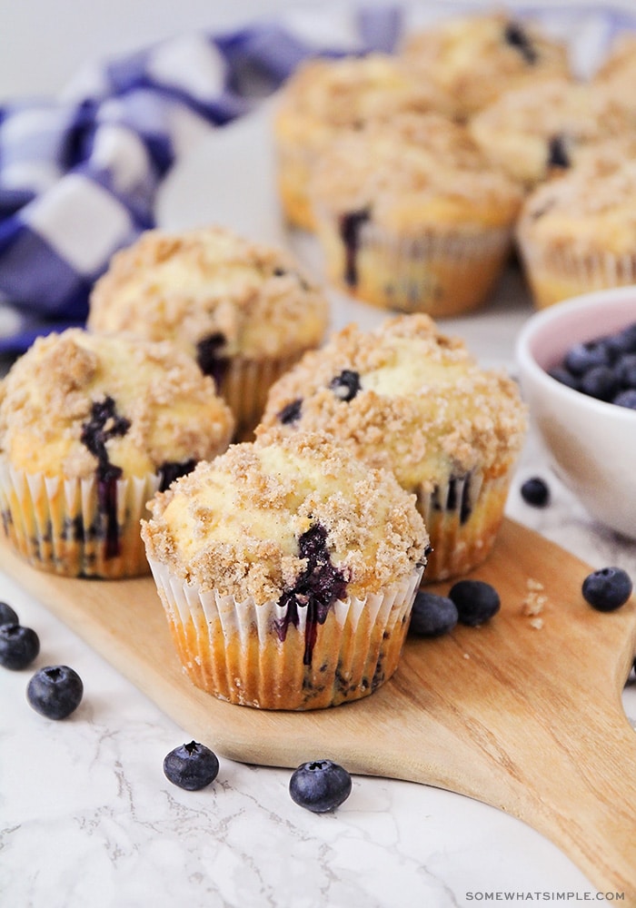 long image of blueberry muffins on a wood cutting board