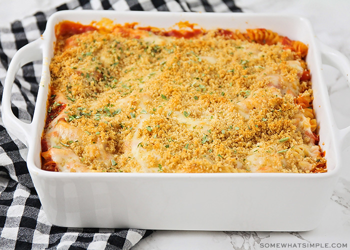 a casserole pan filled with this easy chicken parmesan casserole recipe. The casserole is fresh from the oven with golden brown bread crumbs on top and parsley sprinkled on top.