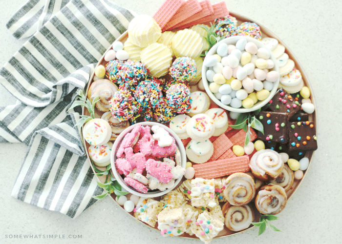 looking down on an Easter dessert tray filled with an assortment of brightly colored cookies and desserts.