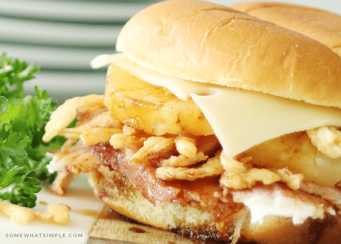 a ham sandwich on a King's Hawaiian roll with fried onions and pinapple