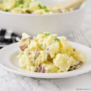 a plate with a serving of potato salad made with mustard and hard boiled eggs.