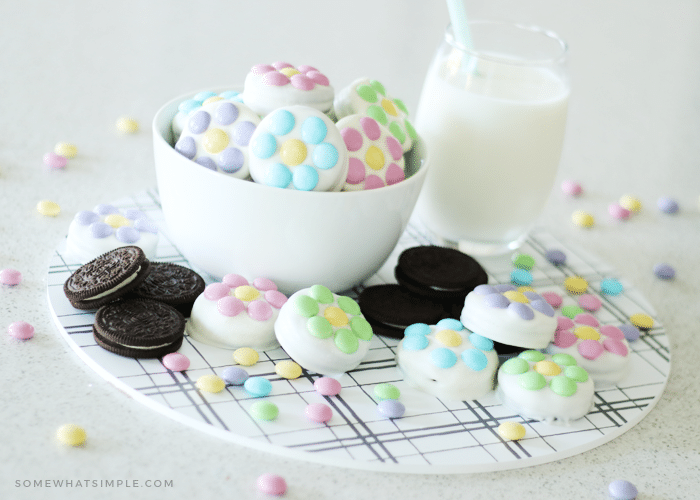 bowl of chocolate covered oreos next to a glass of milk