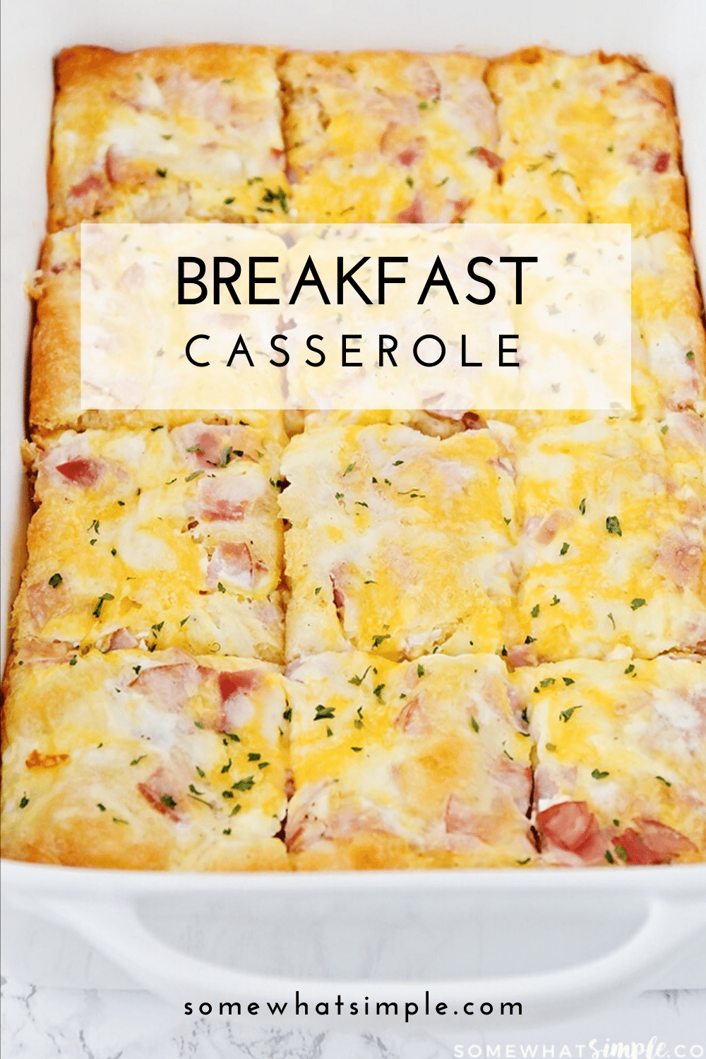 This easy croissant breakfast egg casserole recipe is an easy recipe that is perfect for either breakfast or dinner! Made with eggs, ham (or sausage) and melted cheese baked over a croissant crust that is a perfect way to start the morning! Plus, it only takes minutes to prepare, so you'll have a delicious breakfast in no time! via @somewhatsimple