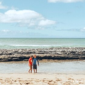 two children playing at Salt Pond beach in Kauai Hawaii