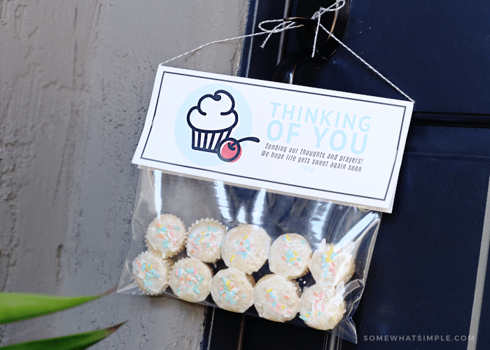 ten mini cupcakes in a plastic bag with a thinking of you tag hanging from the door make a perfect cupcake gift