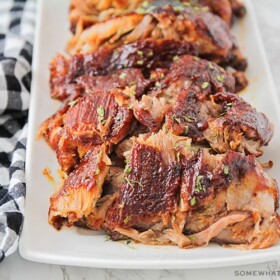 a serving tray filled with ribs where the meat is falling off the bone