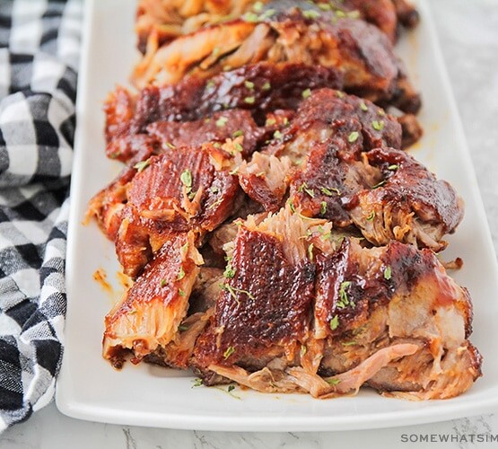 a serving tray filled with ribs where the meat is falling off the bone