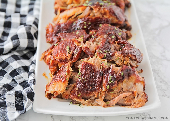 a serving tray filled with ribs where the meat is falling off the bone