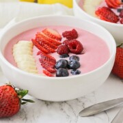 a smoothie bowl topped with sliced fresh fruit