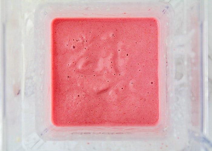 a blender full of blended strawberries