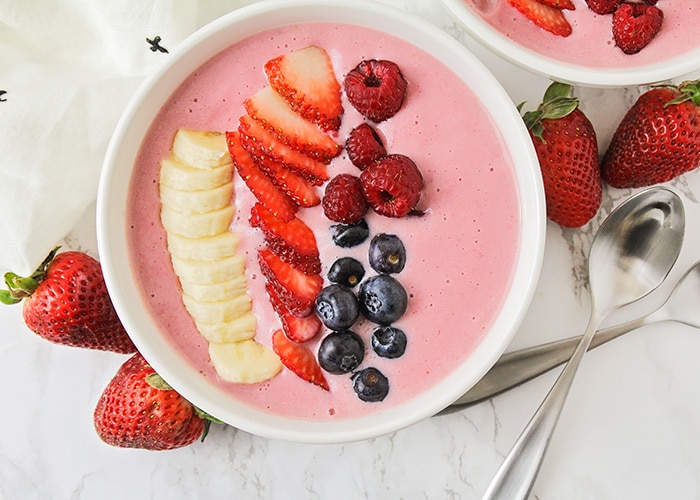 looking down on a smoothie bowl with fresh fruit on top