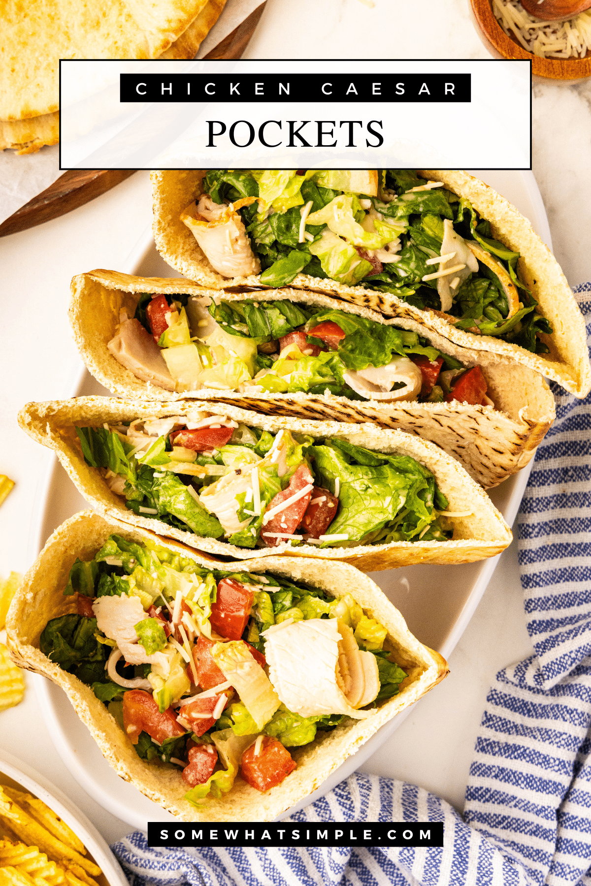 These Caesar Pockets are a quick, no-cook meal perfect for summer! Fresh lettuce, turkey, and Parmesan tossed in Caesar dressing and stuffed into pita bread. via @somewhatsimple