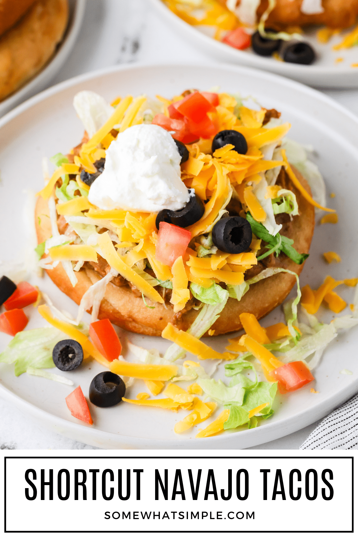 Easy Navajo Tacos made with shortcut Indian fry bread is a quick, family-friendly dinner piled high with beef, beans, and your favorite taco toppings. via @somewhatsimple