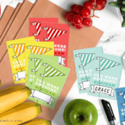 different colored team snack bag printables spread out on the counter