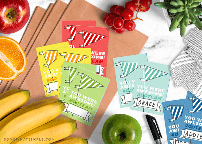 different colored team snack bag printables spread out on the counter