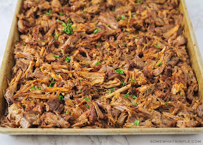 a baking sheet filled with crispy pulled pork