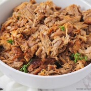 a bowl filled with shredded pulled pork that was made in an instant pot